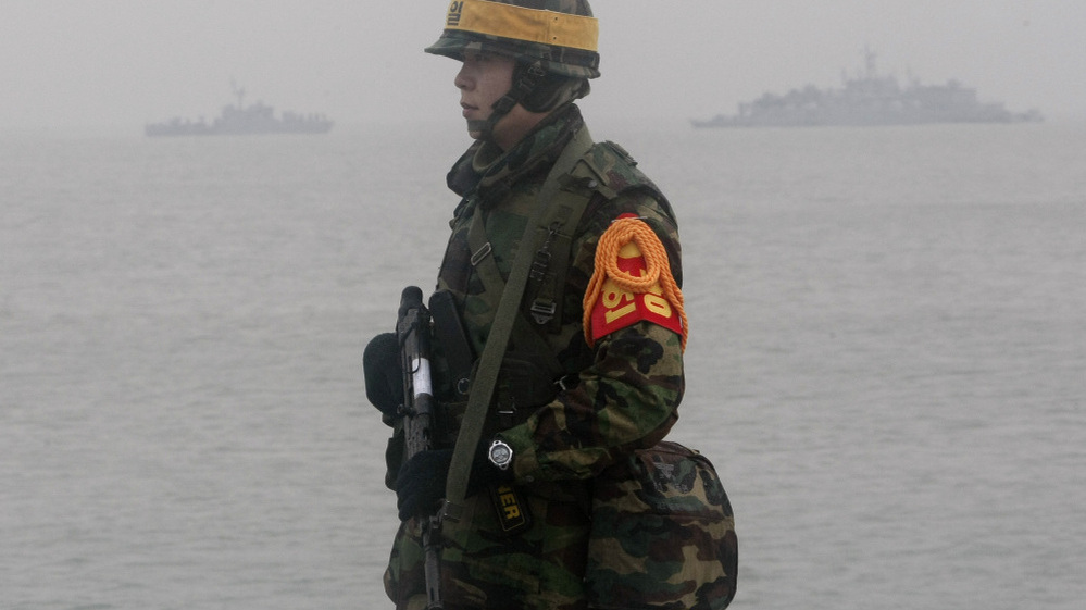 A South Korean marine stands guard on Yeonpyeong island on Friday.