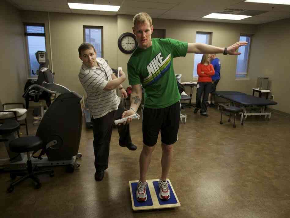 Brendan Jannesen, 23, plays Wii ping pong has part of his balancing therapy with physical therapist Brian Smith. Brendan Jannesen, 23, plays Wii ping pong has part of his balancing therapy with physical therapist Brian Smith.