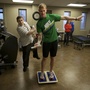 Brendan Jannesen, 23, plays Wii ping pong has part of his balancing therapy with physical therapist Brian Smith.