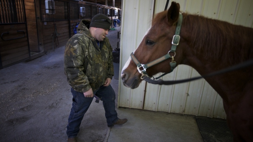 Bobby McKinney, 29, prepares to groom a horse at the Chastain Horse Park in Atlanta.