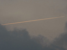 A vapor trail is left by reconnaissance plane over a South Korean island near the disputed Korean border. A vapor trail is left by reconnaissance plane over a South Korean island near the disputed Korean border.