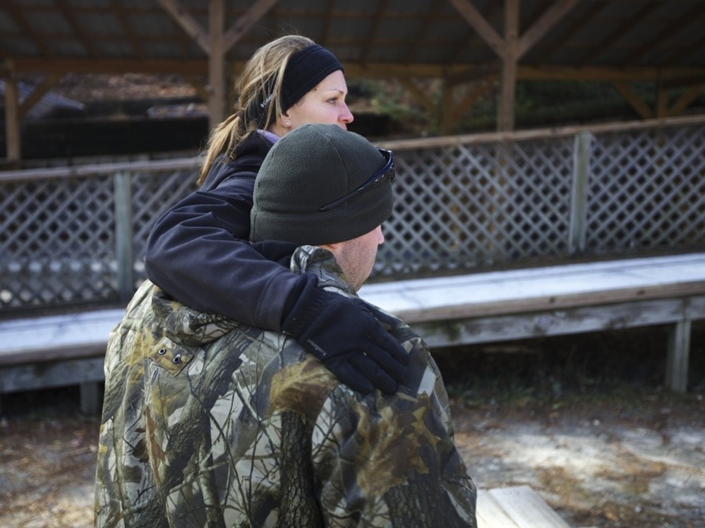 Bobby McKinney, 29, hugs Becky Bunnell, an instructor at the Chastain Horse Park with its therapeutic program.