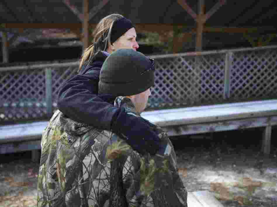 Bobby McKinney, 29, hugs Becky Bunnell, an instructor at the Chastain Horse Park with its therapeutic program.
