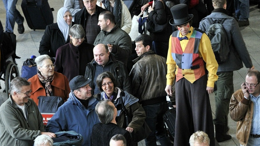 A clown entertains stranded travelers at the Frankfurt airport on December 19, 2010. 