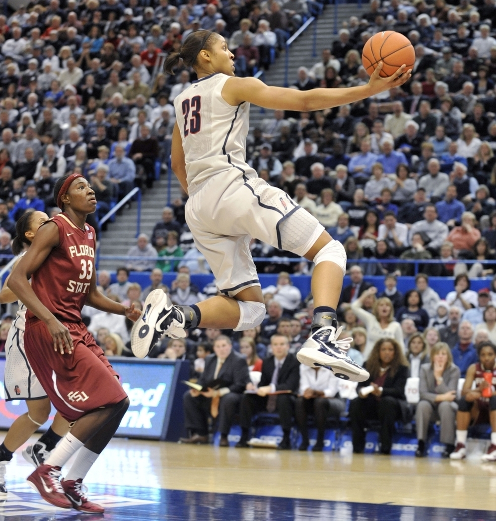 Connecticut forward Maya Moore drives for a layup in front of  Florida State forward Natasha Howard.