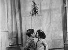Children kissing under mistletoe. Children kissing under mistletoe.