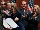 Tuesday: Former U.S. Air Force Major Michael D. Almy (L) hugs House Speaker Nancy Pelosi, D-CA, after she signed legislation repealing "don't ask, don't tell." It's now on the president's desk, awaiting his signature today.