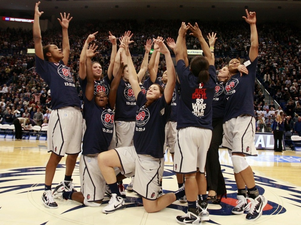 The Connecticut women's basketball team celebrates after their record-setting 89th straight win.
