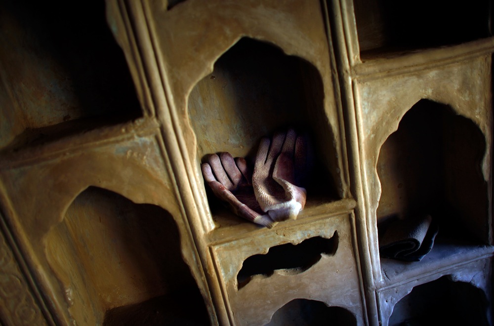 Construction gloves rest on shelves of newly completed ornate plaster work in one of the homes in Murad Khane.