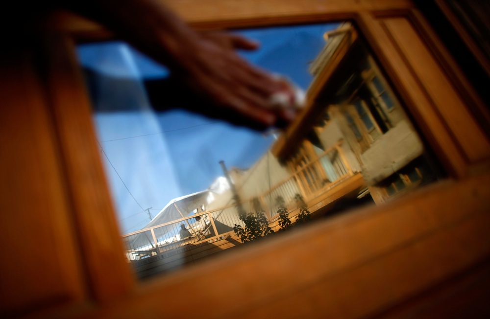 A window reflects the newly renovated buildings. The Turquoise Mountain Foundation is working to conserve the historical richness of Murad Khane.