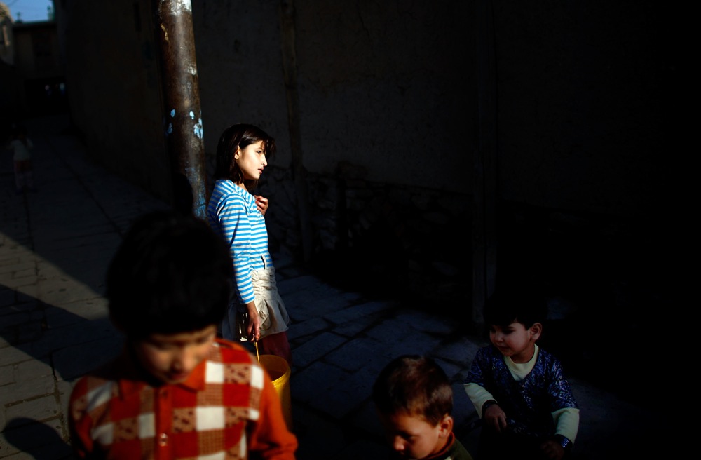 Afghan children are seen in an alley in Kabul's Old City. The buildings of Murad Khane were originally built to house members of the Afghan ruler's court and family.