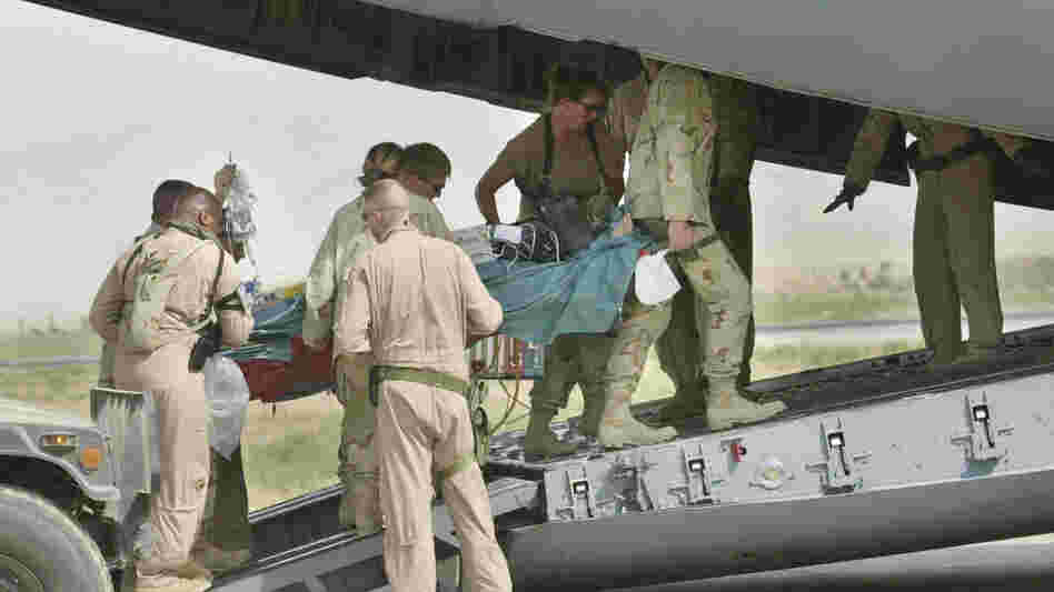 Army medics and soldiers carry a wounded soldier onto an Air Force C-17 at Bagram Air Field in this Aug. 8, 2002 photo. Members from the Aeromedical Evacuation Squadron at Bagram quickly reconfigure the hold of the massive cargo plane into a flying hospital that will take wounded troops from the war zone to American hospitals in Europe and the States. Army medics and soldiers carry a wounded soldier onto an Air Force C-17 at Bagram Air Field in this Aug. 8, 2002 photo. Members from the Aeromedical Evacuation Squadron at Bagram quickly reconfigure the hold of the massive cargo plane into a flying hospital that will take wounded troops from the war zone to American hospitals in Europe and the States.