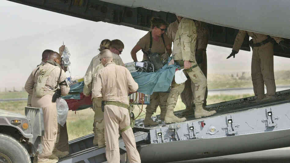 Army medics and soldiers carry a wounded soldier onto an Air Force C-17 at Bagram Air Field in this Aug. 8, 2002 photo. Members from the Aeromedical Evacuation Squadron at Bagram quickly reconfigure the hold of the massive cargo plane into a flying hospital that will take wounded troops from the war zone to American hospitals in Europe and the States. Army medics and soldiers carry a wounded soldier onto an Air Force C-17 at Bagram Air Field in this Aug. 8, 2002 photo. Members from the Aeromedical Evacuation Squadron at Bagram quickly reconfigure the hold of the massive cargo plane into a flying hospital that will take wounded troops from the war zone to American hospitals in Europe and the States.