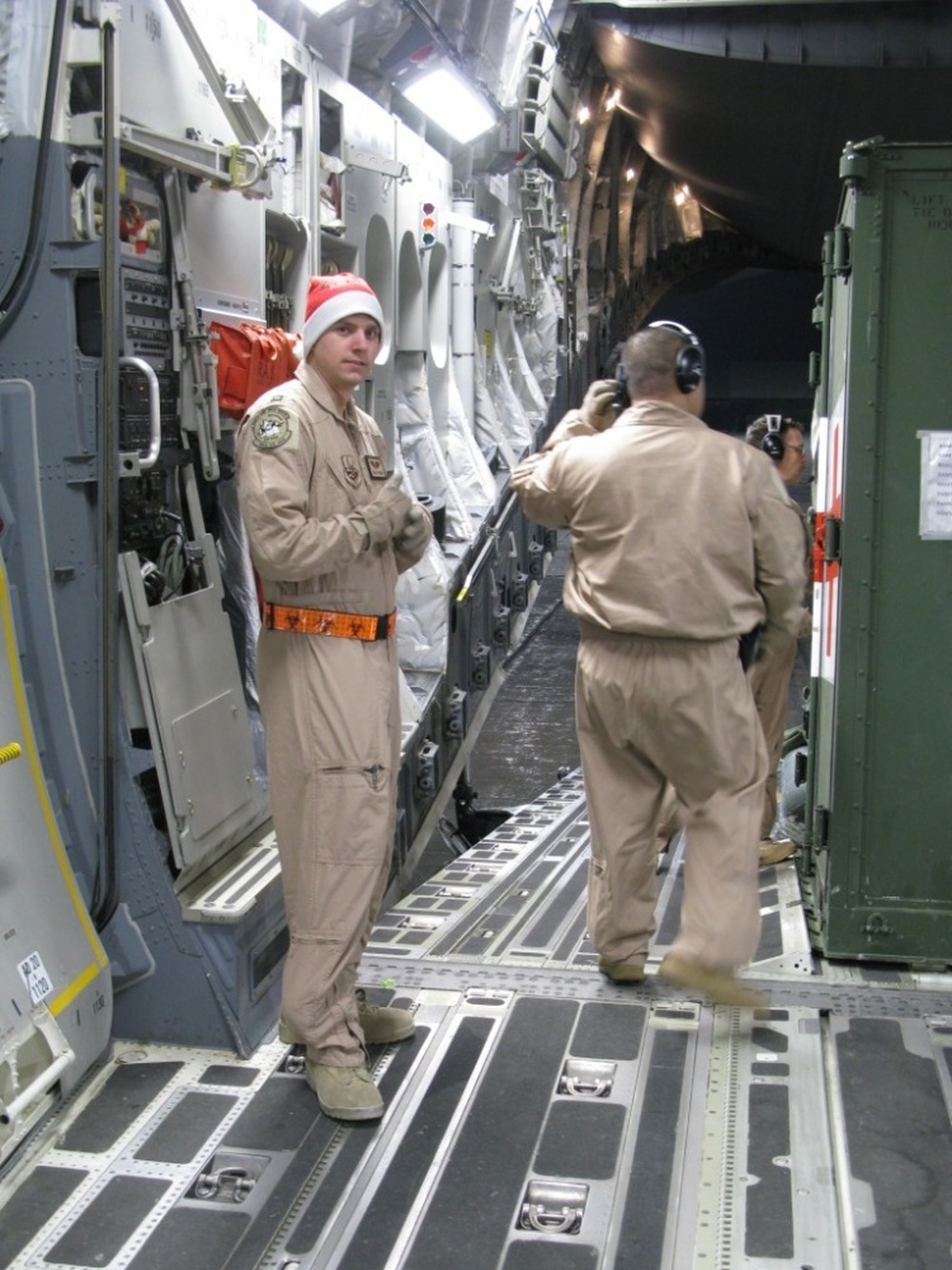 Air Force Capt. Blake Putnam, left, helps convert the massive hold of the C-17 plane from carrying cargo into a flying hospital.