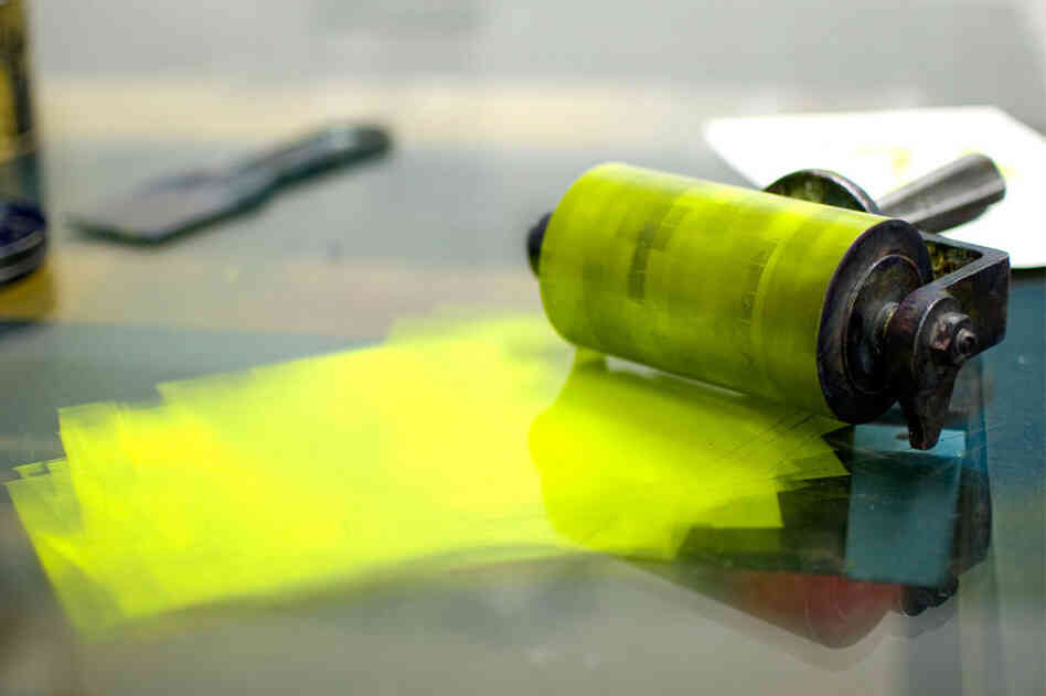The brayer, after ink has been applied to the LEGO relief for a proof run.