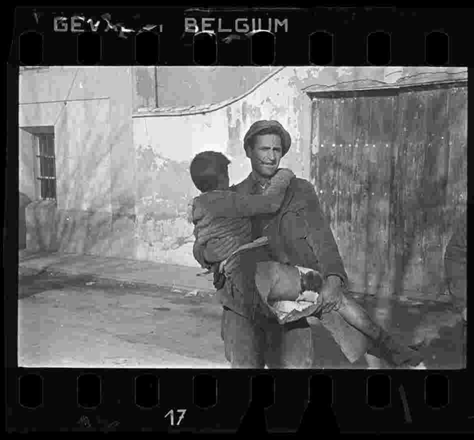 Man carrying a wounded boy, Teruel, Spain, late Dec. 1937 