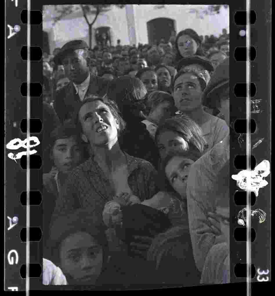 Mother nursing a baby while listening to political speech, near Badajoz, Extremadura, Spain, late April - early May 1936 )