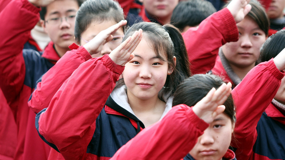 Chinese students salute during a flag-raising ceremony at a junior high school in Shanghai, China, Feb. 22, 2010. For the first time, Chinese students participated in international standardized testing -- and came out on top.