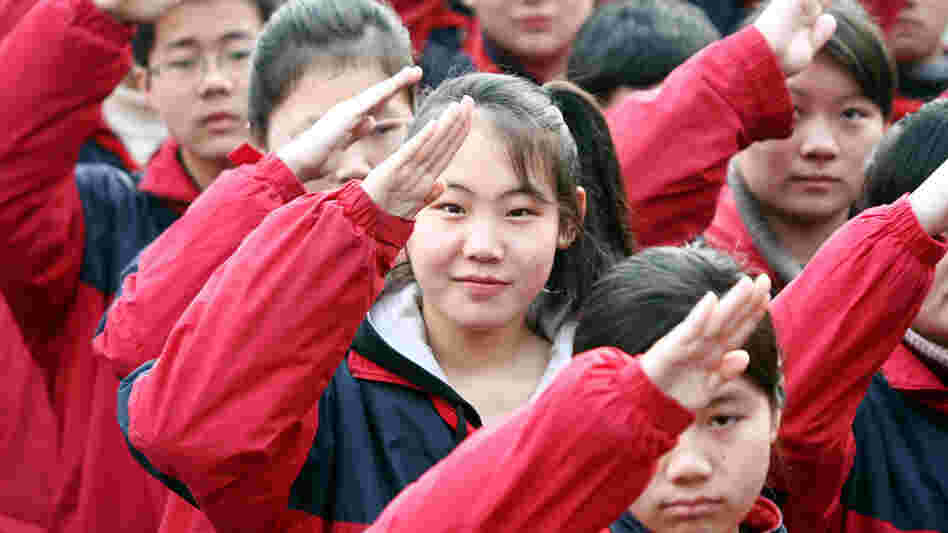 Chinese students salute during a flag-raising ceremony at a junior high school in Shanghai, China, Feb. 22, 2010. For the first time, Chinese students participated in international standardized testing -- and came out on top.