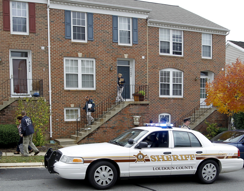 FBI and law enforcement investigators leave the home of Farooque Ahmed in Ashburn,  Va., on Oct. 27. Ahmed was charged with trying to help people he believed were al-Qaida operatives plan to bomb subway stations around Washington,  D.C.