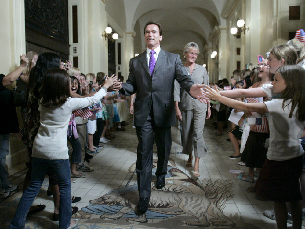 Gov. Arnold Schwarzenegger is greeted by children as he walks to a ceremony to honor Olympic athletes from California at the state Capitol in 2008. Despite his ability to draw a crowd, Schwarzenegger leaves office on a low note, with an approval rating of just 23 percent.