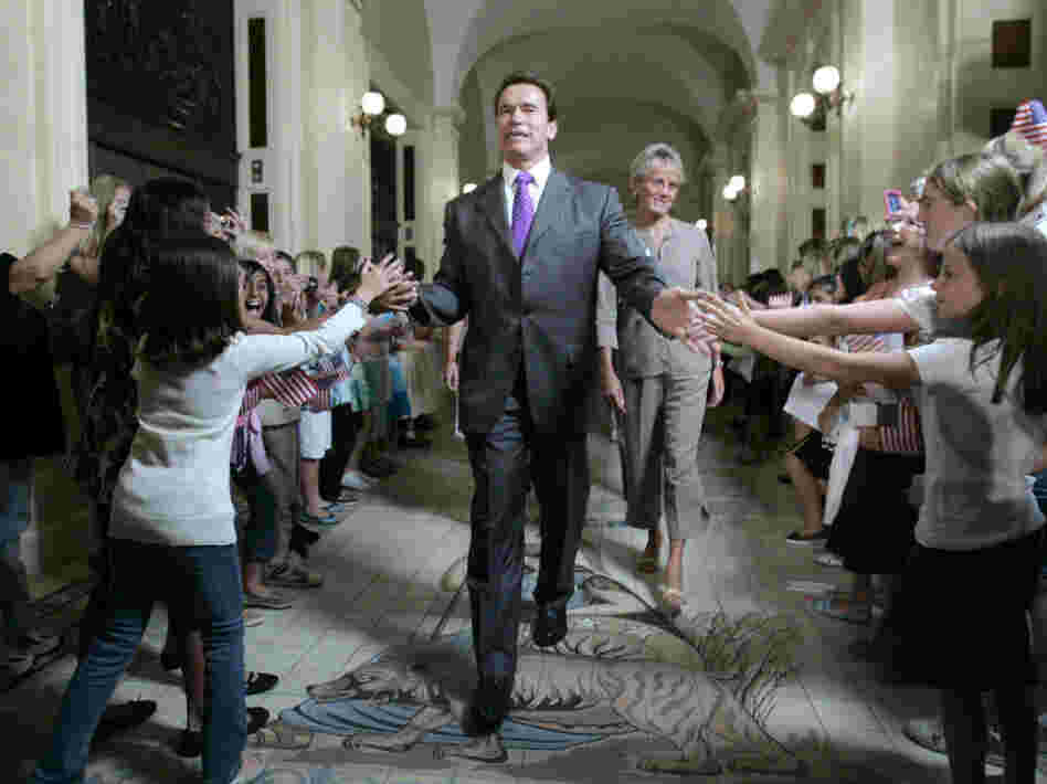 Gov. Arnold Schwarzenegger is greeted by children as he walks to a ceremony to honor Olympic athletes from California at the state Capitol in 2008. Despite his ability to draw a crowd, Schwarzenegger leaves office on a low note, with an approval rating of just 23 percent.