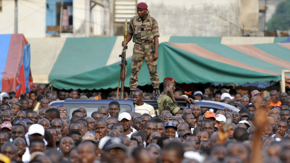 An Ivory Coast soldier stands guard during a rally held by Charles Ble Goude (unseen), leader of Ivory Coast's Young Patriots, in Abidjan on Wednesday. Defiant Ivory Coast leader Laurent Gbagbo's most notorious lieutenant on Wednesday urged the strongman's diehard supporters to launch an unarmed assault on rival Alassane Ouattara's UN-defended base.