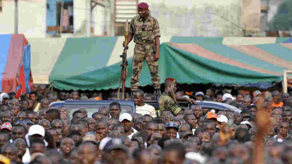 An Ivory Coast soldier stands guard during a rally held by Charles Ble Goude (unseen), leader of Ivory Coast's Young Patriots, in Abidjan on Wednesday. Defiant Ivory Coast leader Laurent Gbagbo's most notorious lieutenant on Wednesday urged the strongman's diehard supporters to launch an unarmed assault on rival Alassane Ouattara's UN-defended base.