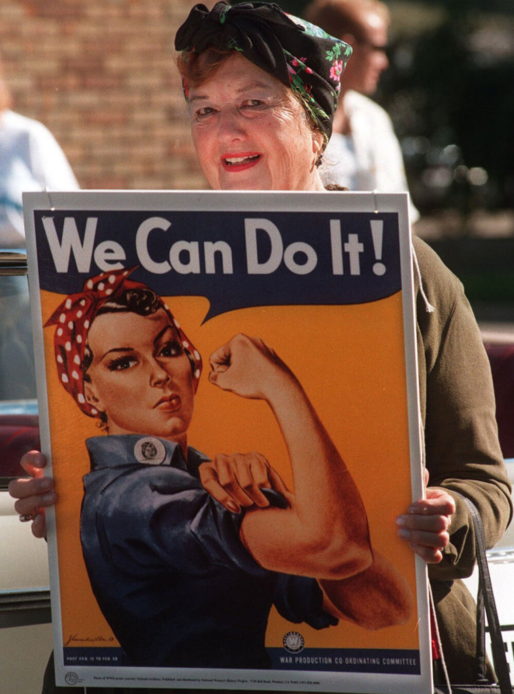 Geraldine Hoff Doyle, in 1997, with a copy of the famous poster her image helped inspire.