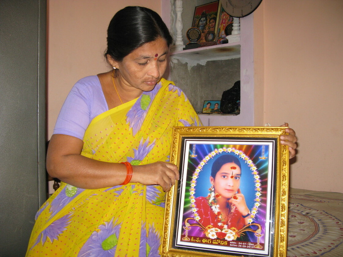 Rama holds a photo of her daughter Mounika, who burned herself to death at the  age of 17.  Rama says her daughter was driven to despair by microloan debt  collectors who harassed the family for payment.