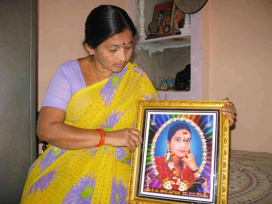 Rama holds a photo of her daughter Mounika, who burned herself to death at the  age of 17.  Rama says her daughter was driven to despair by microloan debt  collectors who harassed the family for payment.