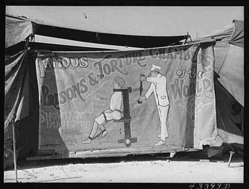 A sign advertises, "Prisons and Torture Chambers of the World."