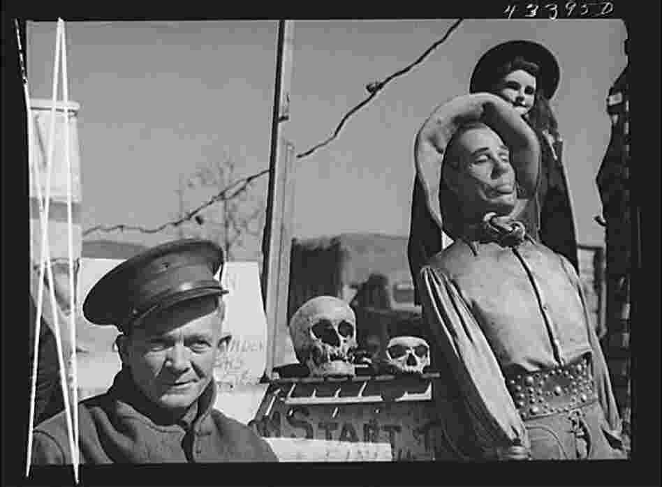 Veteran Claud Thornton, owner of the traveling "crime museum" stands with a few of his effigies near Fort Bragg, N.C.