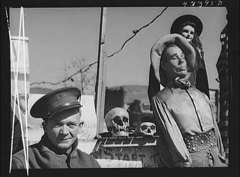 Veteran Claud Thornton, owner of the traveling "crime museum" stands with a few of his effigies near Fort Bragg, N.C.