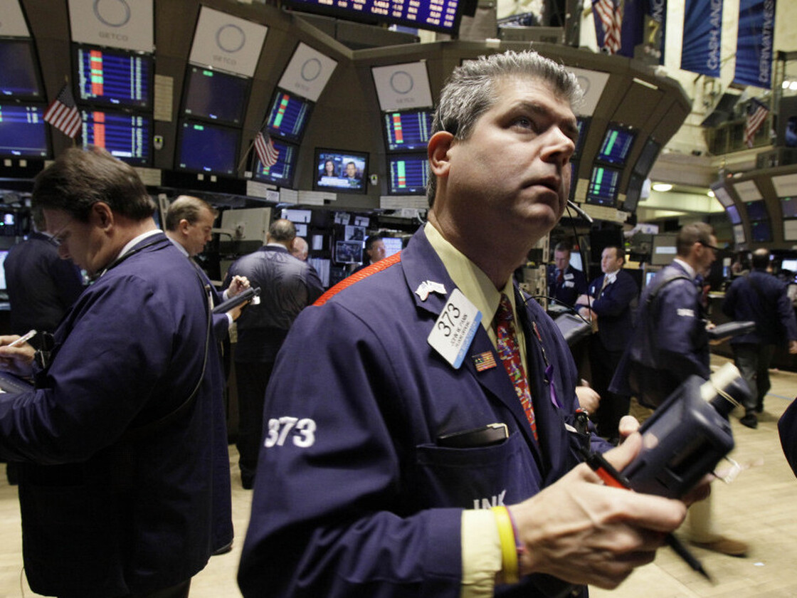 Trader John Panin checks prices on the floor of the New York Stock Exchange.