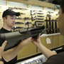 Case Vermillion hands a gun to a customer at the Cheaper Than Dirt gun shop in Fort Worth, Texas, Thursday, Nov. 6, 2008. Case Vermillion hands a gun to a customer at the Cheaper Than Dirt gun shop in Fort Worth, Texas, Thursday, Nov. 6, 2008.
