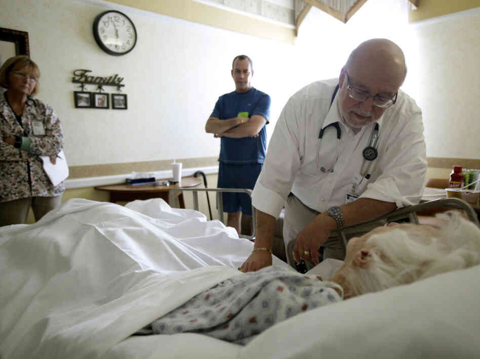 Dr. Joel Policzer checks on Lillian Landry, a patient in the hospice wing of a Fla. hospital. Landry made end-of-life decisions to receive little care.