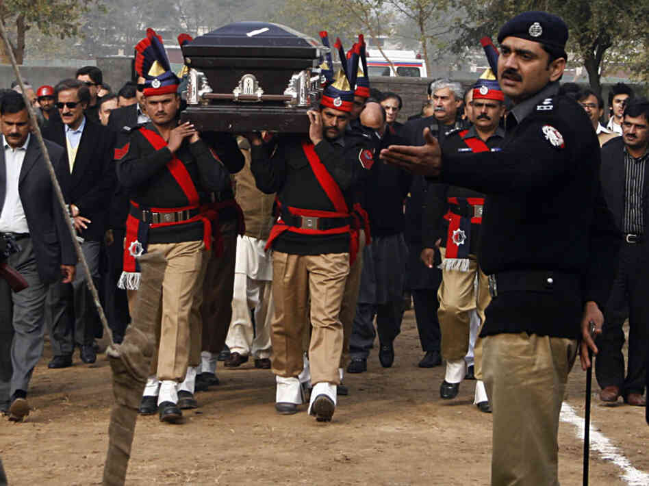 In Lahore, Pakistani police guards carry the coffin of late Punjab governor Salman Taseer ; Jan. 5, 2011.