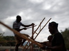 Men build the frames for improvised classrooms to replace a Port au Prince school that collapsed after the Haitian earthquake. Men build the frames for improvised classrooms to replace a Port au Prince school that collapsed after the Haitian earthquake.
