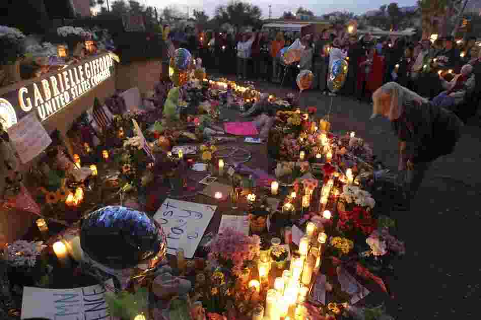 Supporters of U.S. Rep. Gabrielle Giffords (D-AZ) gather for a vigil outside her offices in Tucscon, Ariz. Giffords and 18 others were shot on Saturday outside a local supermarket; six were killed. 