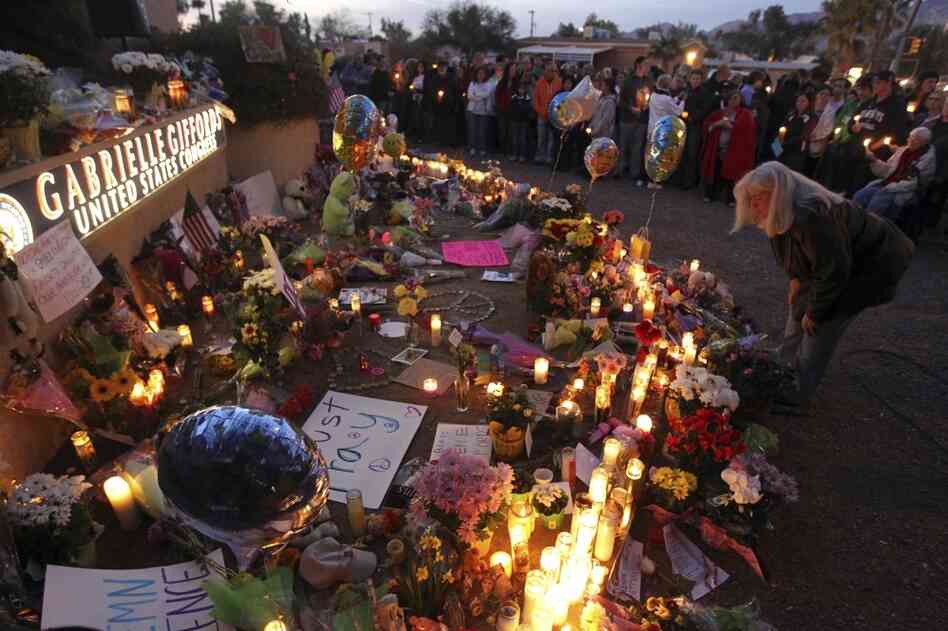 Supporters of U.S. Rep. Gabrielle Giffords (D-AZ) gather for a vigil outside her offices in Tucscon, Ariz. Giffords and 18 others were shot on Saturday outside a local supermarket; six were killed. 