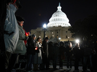 People gather for a candlelight vigil for the victims of the shooting rampage, at the steps of the Capitol in Washington on Saturday.