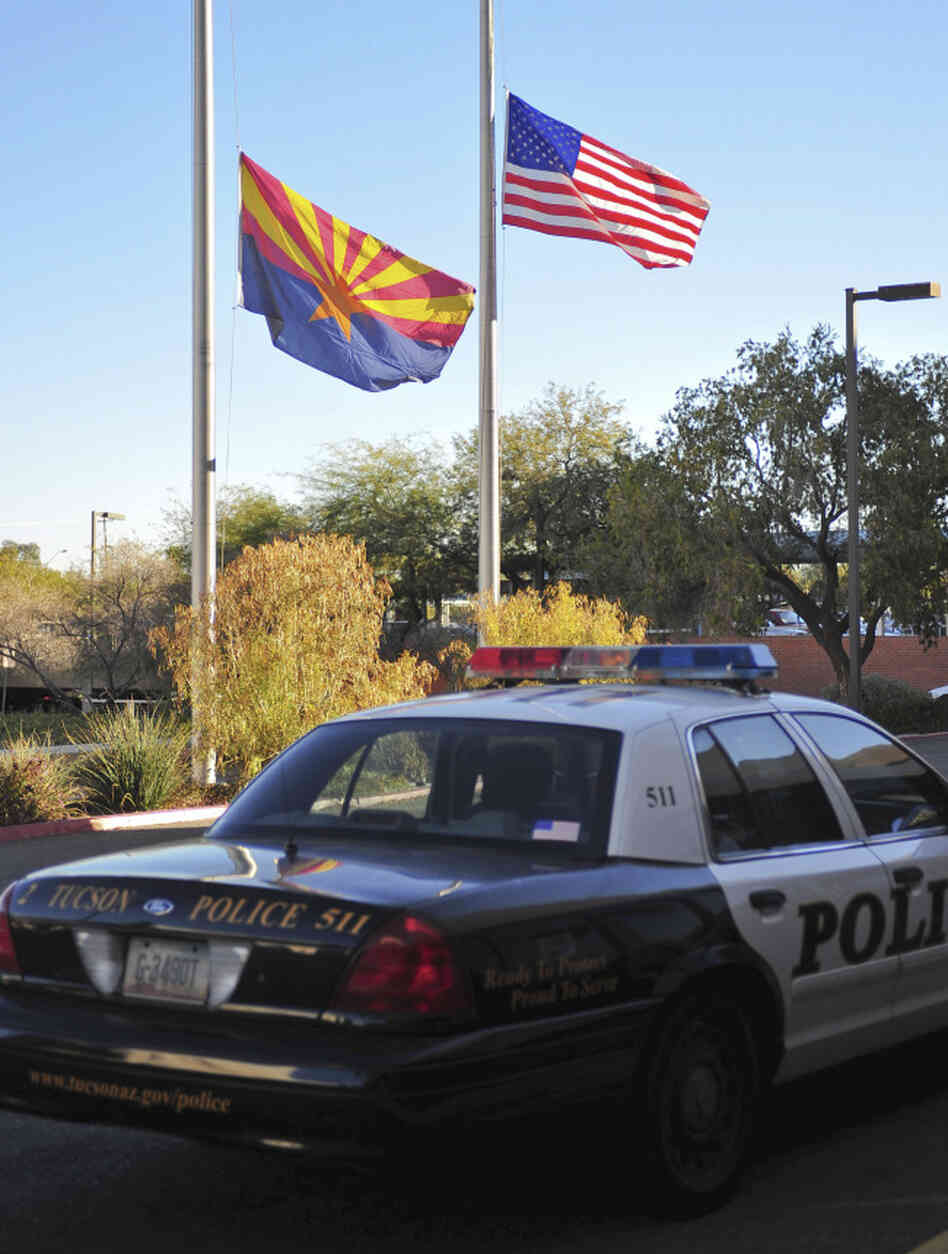 Flags fly at half-mast outside University Medical Center in Tucson where Rep. Gabrielle Giffords and other victims were being treated after being shot today.