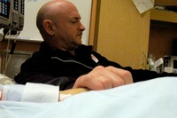 Giffords' husband, Mark Kelly, holds his wife's hand in the congresswoman's hospital room at University Medical Center in Tucson. Giffords remained in critical condition Wednesday.