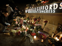 A memorial grows outside the offices of U.S. Rep. Gabrielle Giffords (D-AZ) during a candlelight vigil for Giffords on Saturday in Tucson, Ariz.