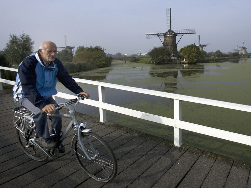 Dutch researchers have found that those with atypical parkinsonism were less likely to be able to ride a bike compared with patients with Parkinson's disease. A Dutch man who was not in the study rides his bike in front of windmills in Kinderdijk, the Netherlands in 2007.