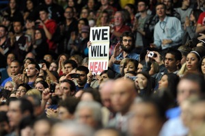 People attend the memorial event, "Together We Thrive: Tuscon and America" at the McKale Memorial Center in Tucson, Ariz., on Wednesday to pay tribute to the six people who were killed and the 14 wounded in the assassination attempt on congresswoman Gabrielle Giffords, who is fighting for her life in hospital.