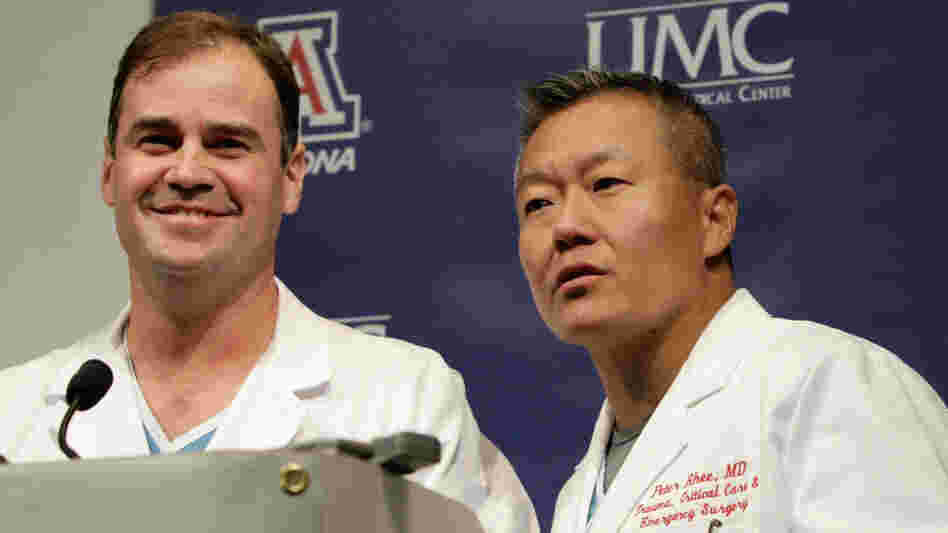 Dr. G. Michael Lemole, Jr., left, looks on as Dr. Peter Rhee talks about the condition of U.S. Rep. Gabrielle Giffords (D-AZ), at University Medical Center during a news conference in Tucson, Ariz., Monday, Jan. 10, 2011.