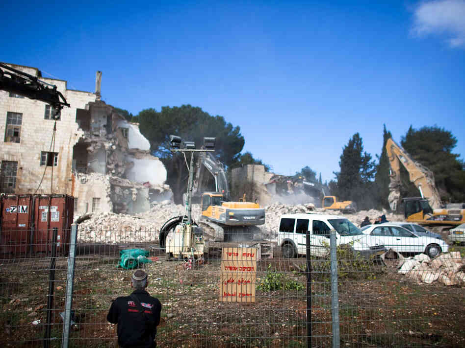 Israeli bulldozers demolish the Shepherd Hotel. Israeli bulldozers demolish the Shepherd Hotel.