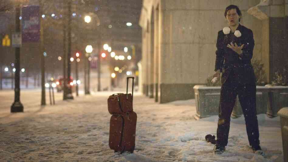 Adrian Hagen of Florida stops to juggle snow balls while walking along Peachtree Street in Atlanta.
